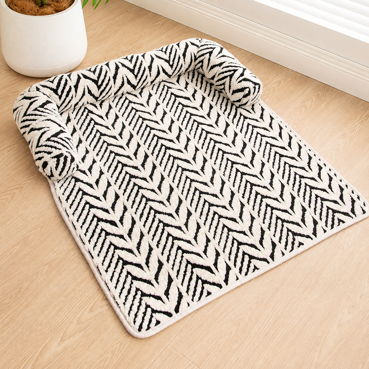 Black and white plush anti-slip pet mat laid flat on a wooden floor