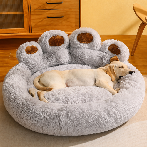 Grey paw-shaped plush pet nest bed with a sleeping yellow Labrador